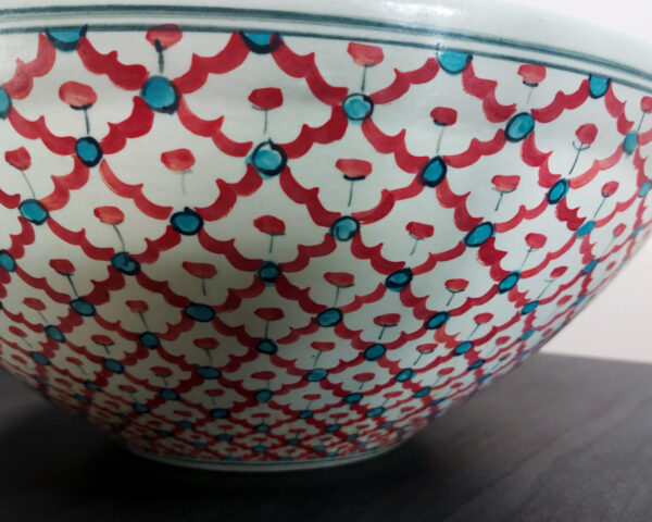 Side profile of Crimson Weave handmade ceramic basin, showcasing form and artisan painting.