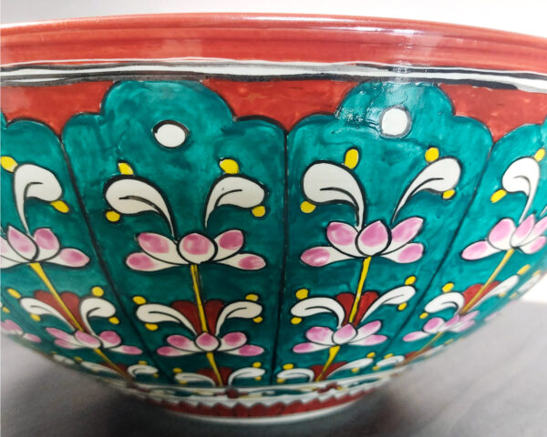 Side profile of Emerald Garden handmade ceramic basin, highlighting painted garden elements and form.
