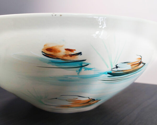 Side profile of Forest Serenity handmade ceramic basin, showing painted landscape and craftsmanship.