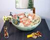 Hand painted Peacock Grace ceramic basin, front view of handmade Thai porcelain sink with peacock feather motifs.
